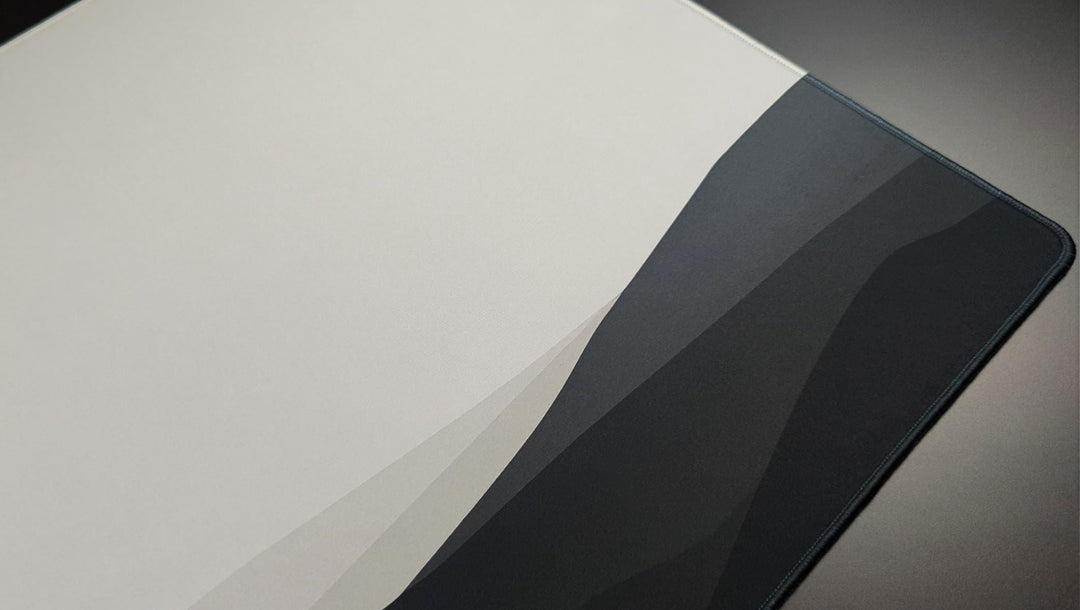 Close up on surface of a custom mousepad with minimalistic black and white landscape print.